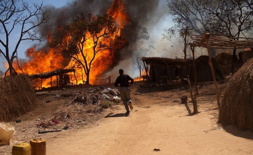 Local mining village on fire after gang attack.